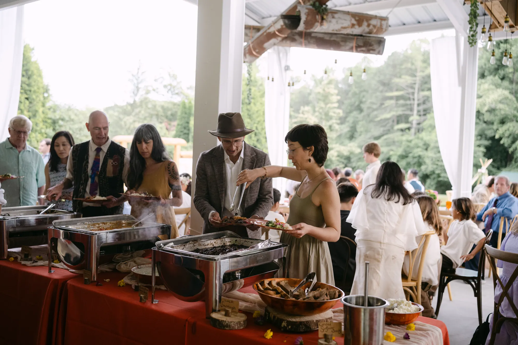 Wedding guests filling their plates along the Kinship buffet